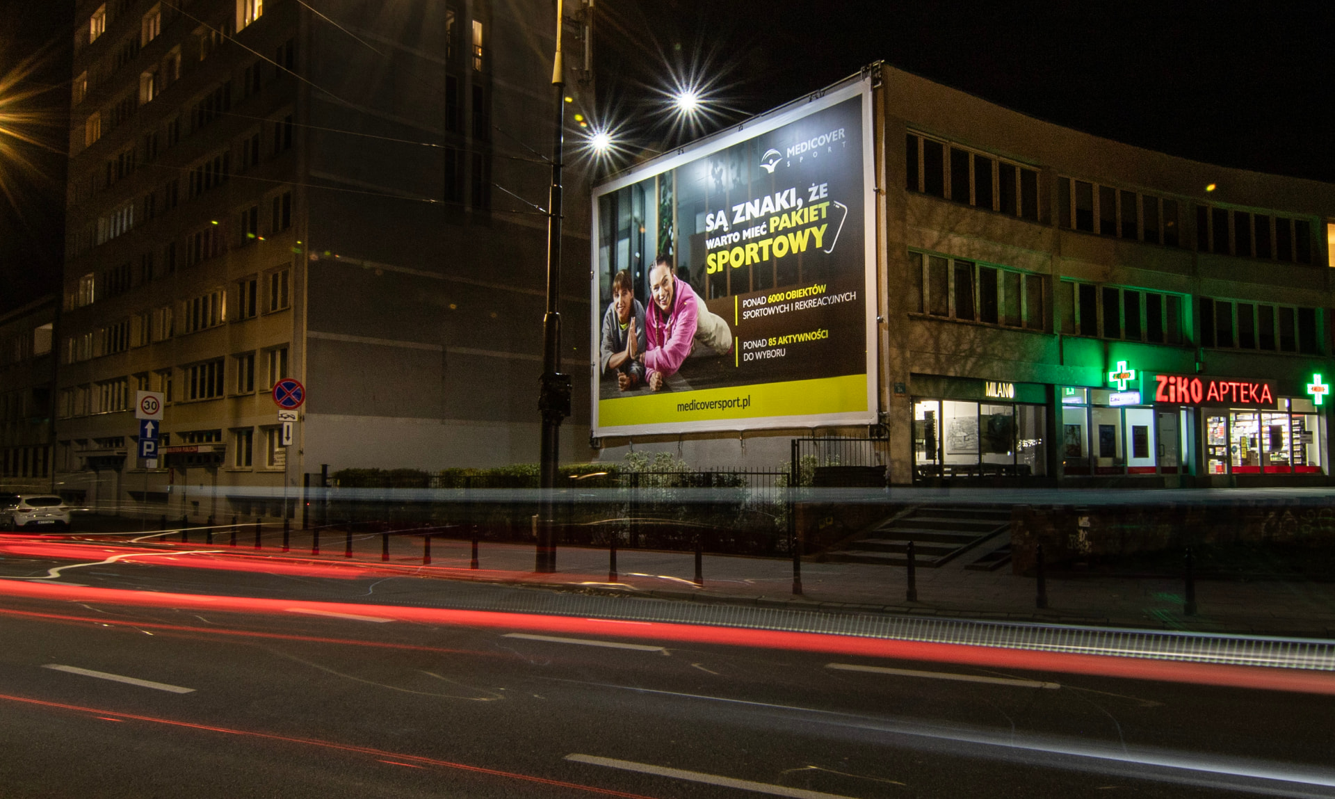 Nocny billboard Medicover Sport na ścianie budynku